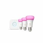 Ett startkit frn Elbutik.se med Philips Hue-lampor och en styrningsenhet visas mot vit bakgrund. Lamporna lyser i rosa nyans