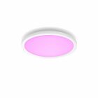 En vit rund LED-taklampa med ljust rosa sken syns monterad mot vit bakgrund.