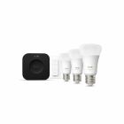 Ett startpaket med Philips Hue smarta LED-lampor, inkluderande tre gldlampor, en trdls dimmer och en svart Hue Bridge