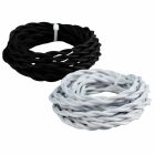 Svarta och vita tvinnade textilkablar ligger upprullade i tv� separata ringar mot en ljus bakgrund.