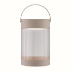 En portabel bordslampa med cylindrisk, r�fflad sk�rm i ljus ton och b�gformat handtag st�r mot neutral bakgrund. Lampan sprider ett mjukt, j�mnt ljus och finns som solcellsbelysning hos Elbutik.se.