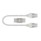 Ett kompakt skarvkit med vita kontakter och kort kabel visas mot ljus bakgrund. COB230-Skarvkit fr�n Elbutik.se anv�nds f�r s�ker och smidig sammankoppling av Designlight Cobby 230V LEDlister i olika belysningsinstallationer.